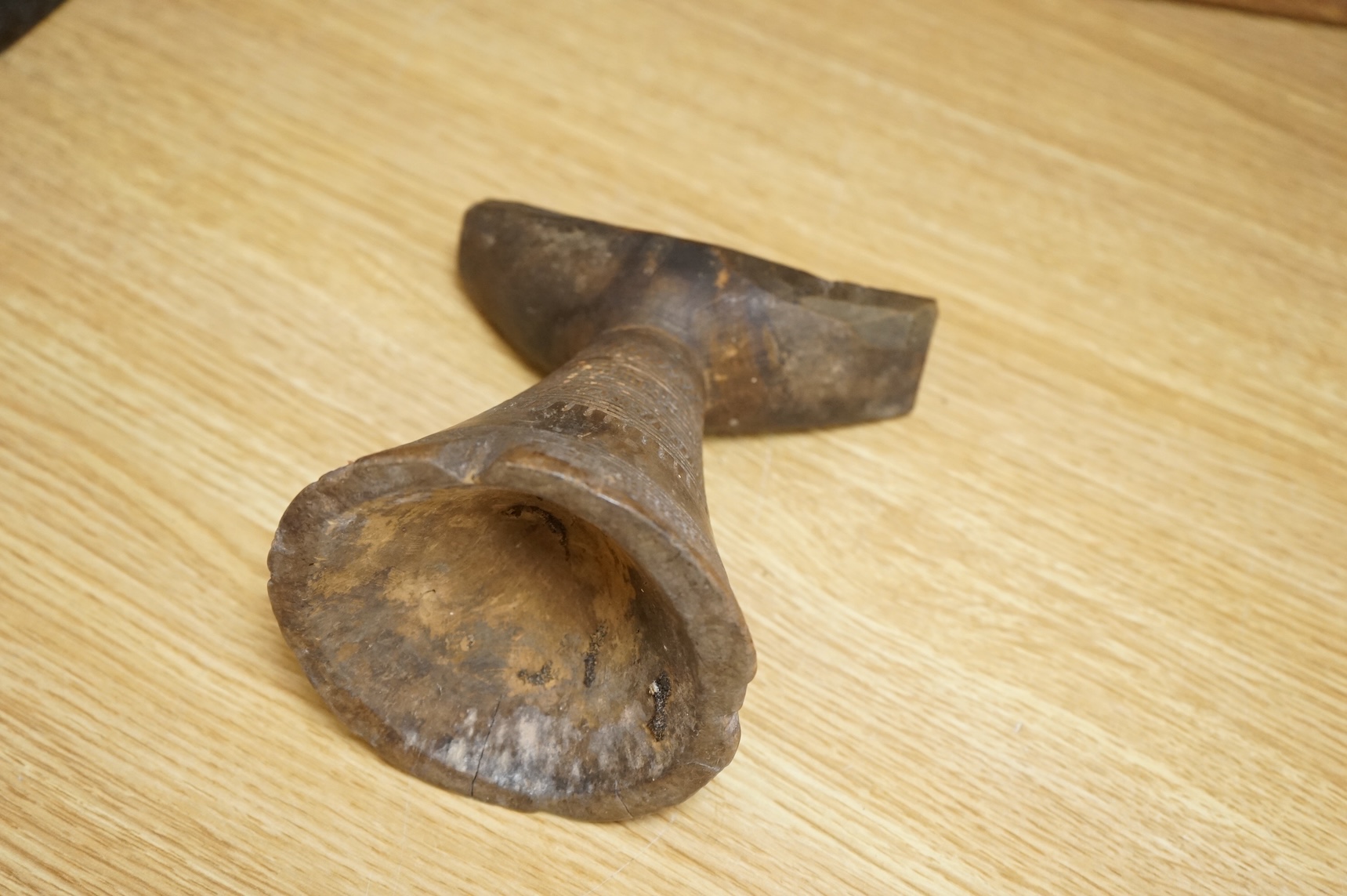 An Ashanti carved wood stool together with a similar headrest, tallest 41cm